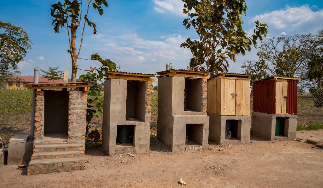 Several latrine designs built side by side for display